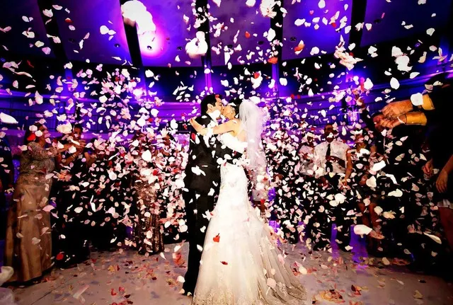 Confetti shower during the wedding dance Bride and groom dancing under a shower of confetti.
