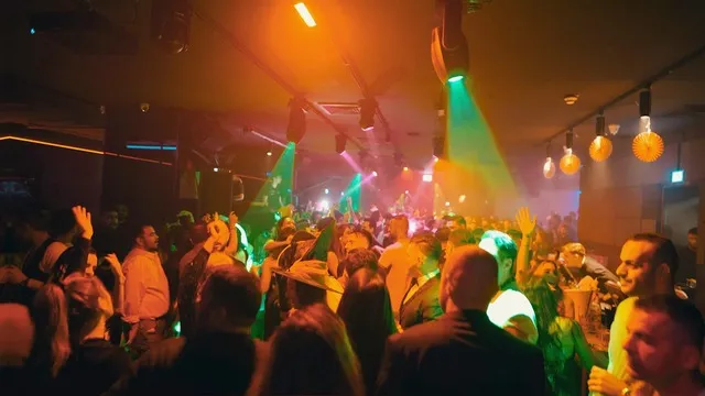 Gäste feiern ausgelassen im Club mit DJ Pouriya
